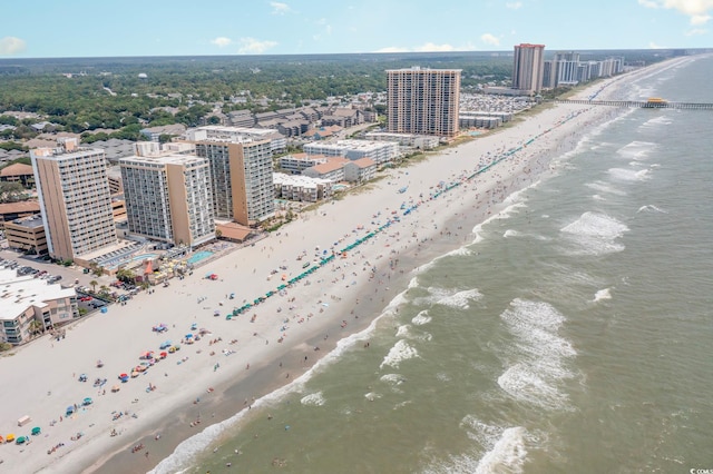 drone / aerial view featuring a water view and a view of the beach