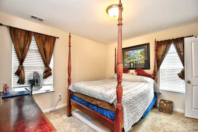 bedroom featuring light carpet