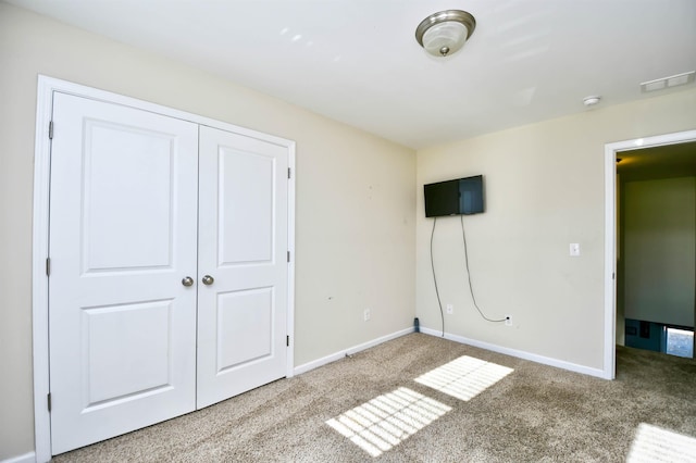 unfurnished bedroom with a closet and carpet floors