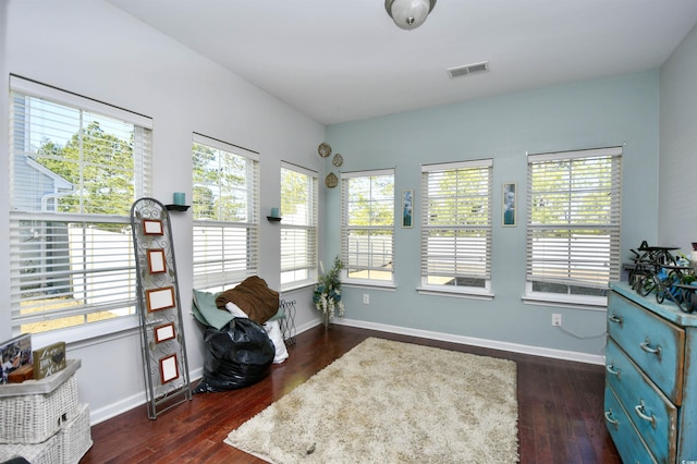 sitting room featuring a wealth of natural light and dark hardwood / wood-style floors