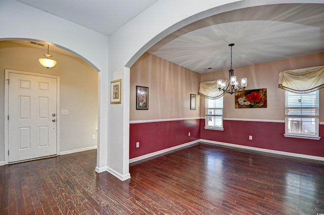 interior space with dark hardwood / wood-style floors and a notable chandelier