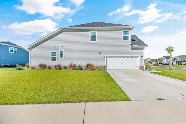 exterior space featuring a garage and a yard