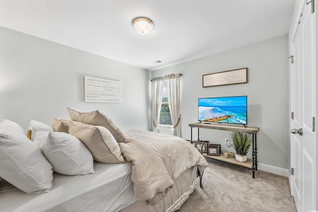 bedroom featuring light carpet