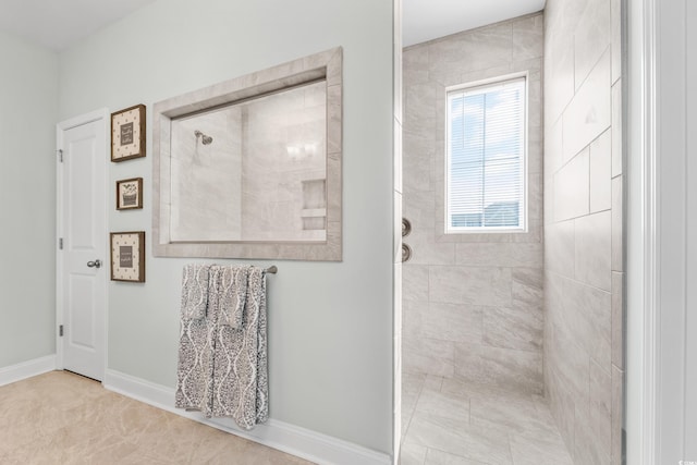 bathroom featuring tile patterned floors and a tile shower