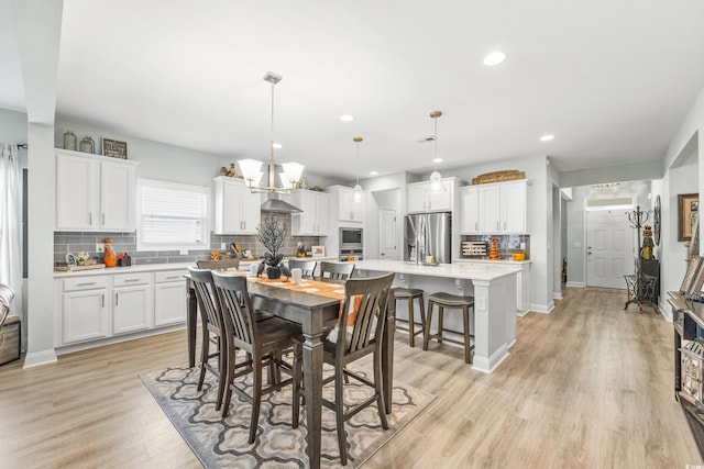 dining space with light hardwood / wood-style floors