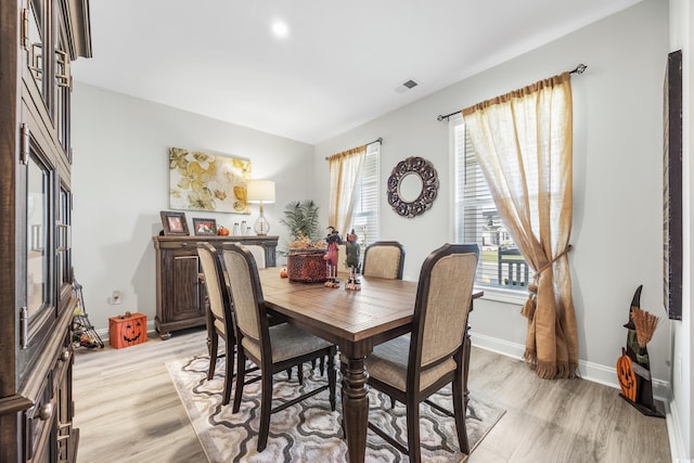 dining space featuring light wood-type flooring