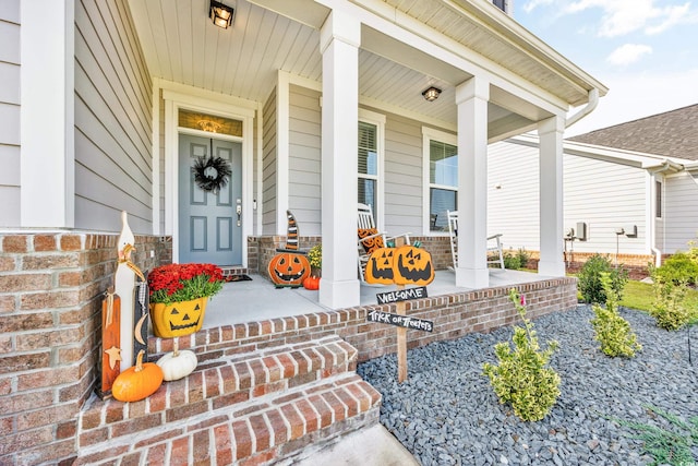 view of exterior entry with covered porch