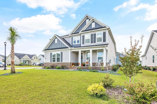 craftsman-style house with a front lawn and covered porch