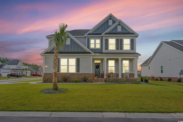 craftsman house with a yard and a porch