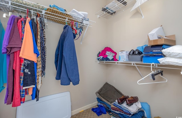 walk in closet with carpet flooring