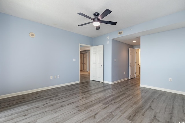 unfurnished bedroom with a textured ceiling, light wood-type flooring, and ceiling fan