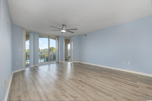 empty room with ceiling fan, a textured ceiling, and light hardwood / wood-style flooring