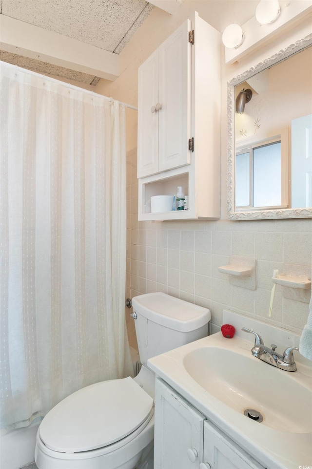 full bathroom featuring shower / bath combo, vanity, toilet, and tile walls