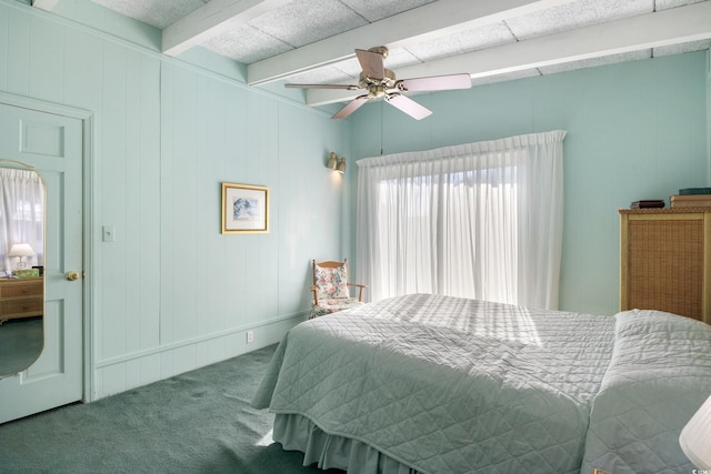 bedroom with carpet, ceiling fan, and beam ceiling