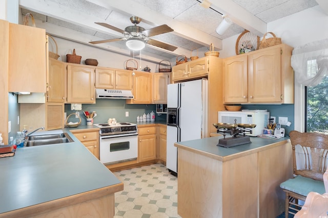 kitchen featuring kitchen peninsula, light brown cabinetry, sink, beamed ceiling, and white appliances