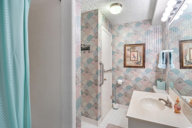 1000 Strand Ave, North Myrtle Beach, SC 29582 - bathroom featuring wallpapered walls, a shower stall, baseboards, and vanity
