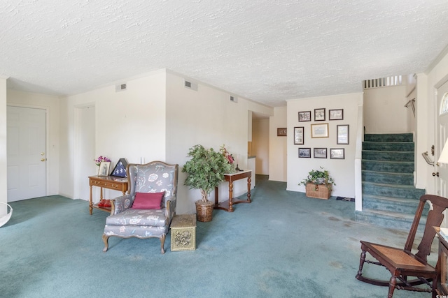 sitting room featuring a textured ceiling and carpet flooring