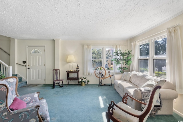 carpeted living room featuring a textured ceiling