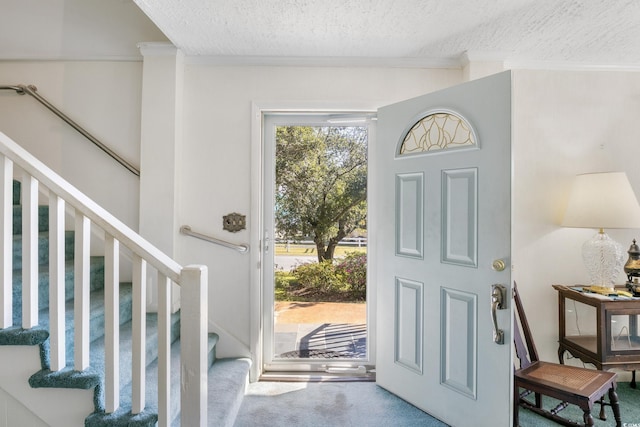 1000 Strand Ave, North Myrtle Beach, SC 29582 - carpeted foyer entrance featuring a textured ceiling, stairway, and ornamental molding
