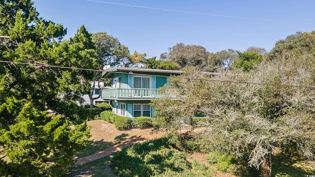 rear view of property featuring a balcony