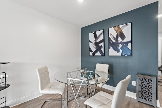 dining space featuring wood-type flooring