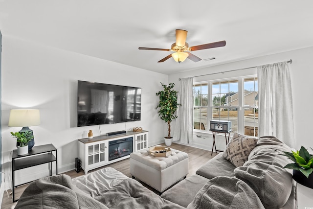 living room featuring hardwood / wood-style flooring and ceiling fan