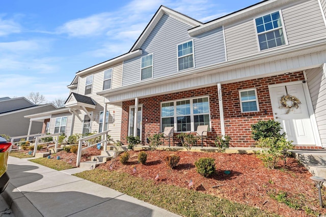 townhome / multi-family property with covered porch