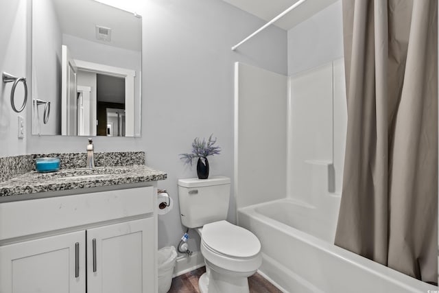 full bathroom with vanity, toilet, shower / bath combo with shower curtain, and wood-type flooring