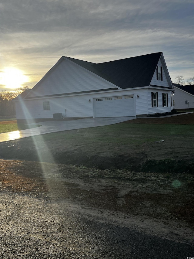 property exterior at dusk with a garage