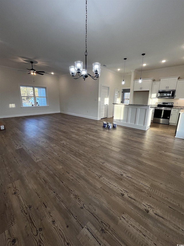 interior space with white cabinets, appliances with stainless steel finishes, ceiling fan with notable chandelier, and decorative light fixtures