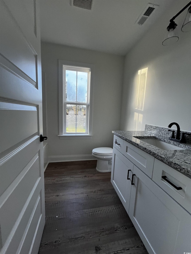 bathroom featuring hardwood / wood-style floors, vanity, and toilet