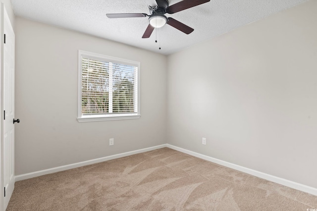 carpeted empty room with a textured ceiling and ceiling fan