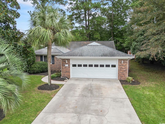 view of front of house with a front yard and a garage