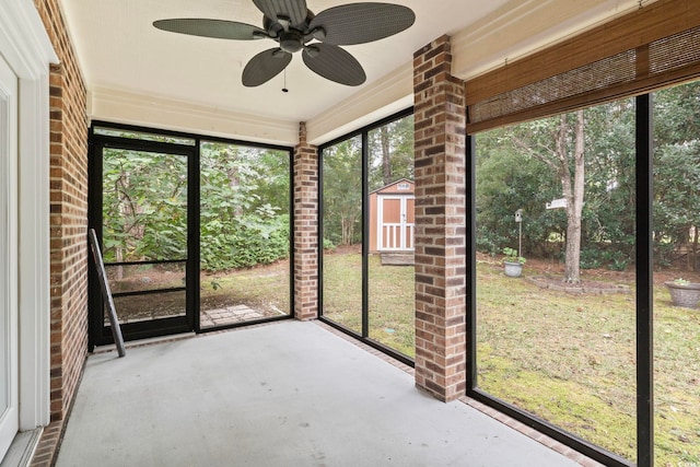 unfurnished sunroom featuring ceiling fan