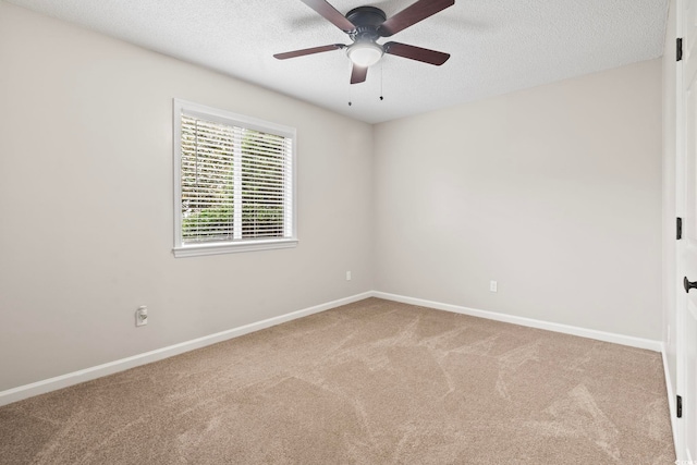 unfurnished room with a textured ceiling, light colored carpet, and ceiling fan