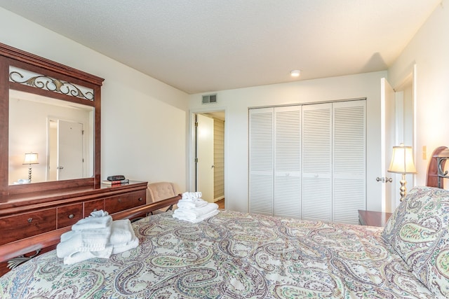 bedroom with a closet and a textured ceiling