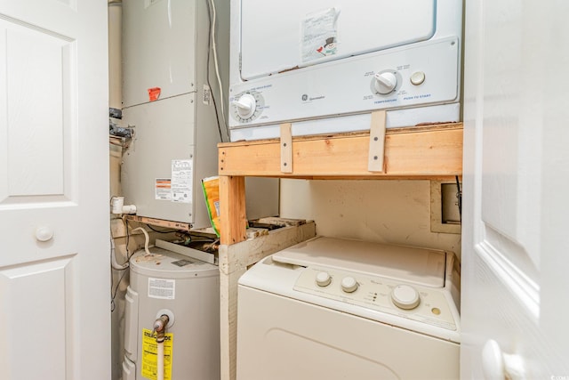 washroom with stacked washer and dryer and electric water heater