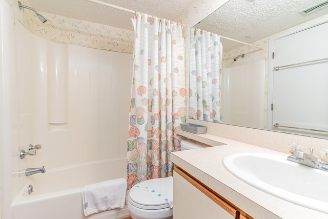 full bathroom featuring vanity, toilet, a textured ceiling, and shower / tub combo with curtain