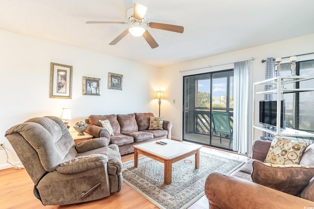 living room featuring ceiling fan and hardwood / wood-style floors