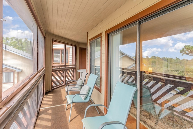 sunroom featuring wood ceiling