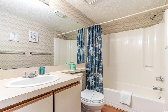 full bathroom with toilet, shower / bath combo, hardwood / wood-style flooring, vanity, and a textured ceiling