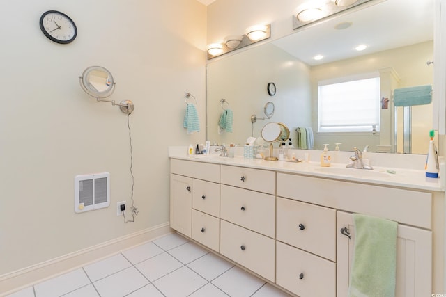 bathroom featuring tile patterned flooring, vanity, and heating unit