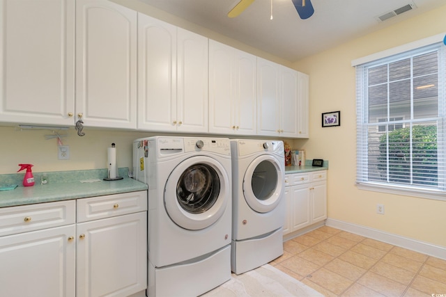 laundry area with ceiling fan, separate washer and dryer, cabinets, and light tile patterned flooring