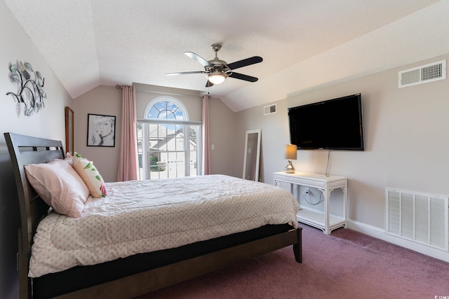 carpeted bedroom featuring vaulted ceiling, ceiling fan, and a textured ceiling