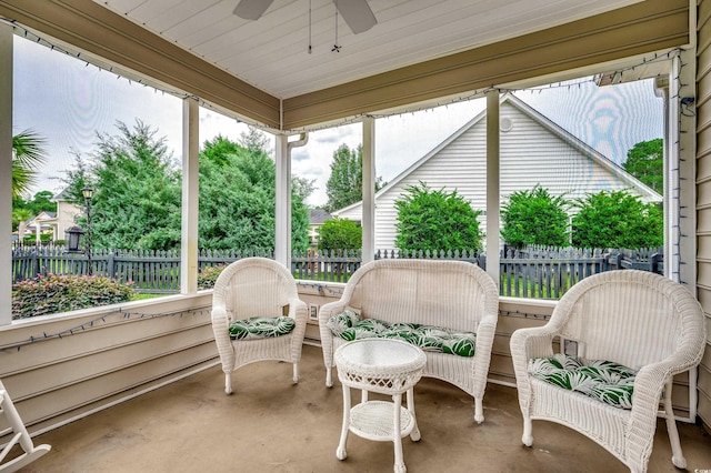 sunroom with ceiling fan and wooden ceiling