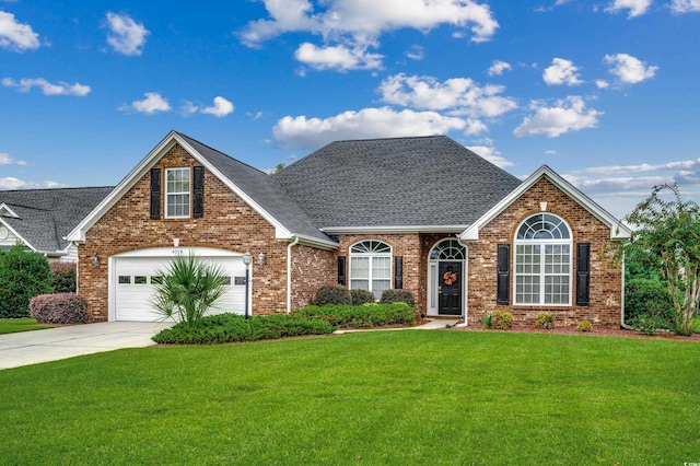 view of front of house with a garage and a front lawn