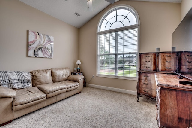 living room featuring vaulted ceiling, light carpet, and a wealth of natural light