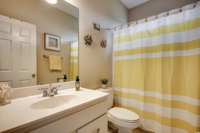 bathroom featuring walk in shower, vanity, and toilet