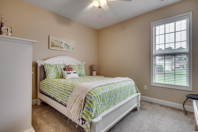 bedroom featuring ceiling fan and carpet