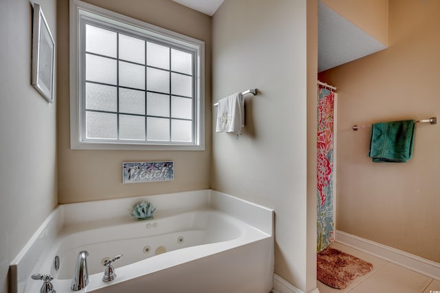 bathroom with shower with separate bathtub and tile patterned floors